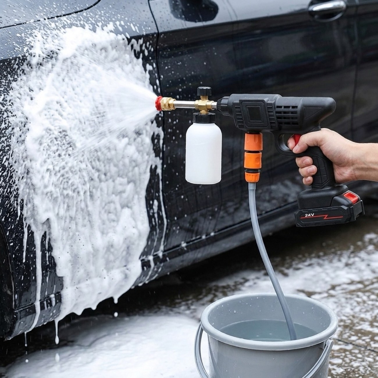 Thick snow foam clinging to dark car paint straight from the brass nozzle