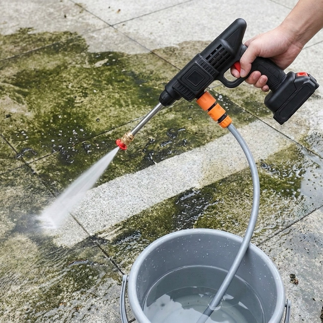 High-pressure fan spray stripping grime off concrete patio slabs